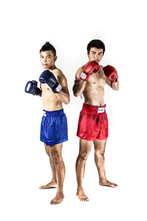 two asian men exercising thai boxing in silhouette studio on white backgroundの写真素材
