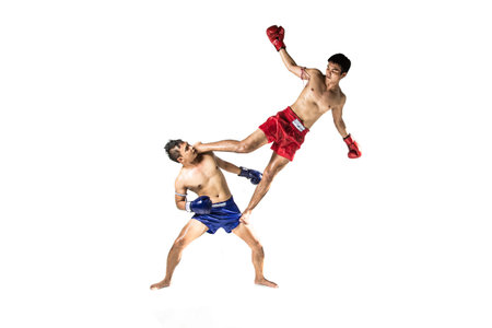 two asian men exercising thai boxing in silhouette studio on white background
