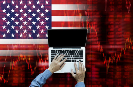 Business person working on laptop computer top view, Crisis in USA - Shares Fall Graph on United States of America Flagの写真素材