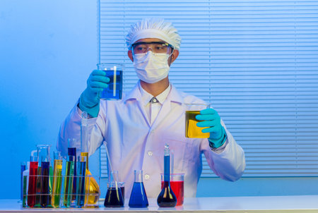 Man scientist holding a test tube with liquid