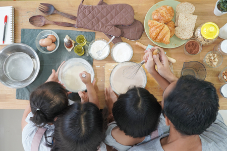 Top view happy family cooks in the kitchen at homeの写真素材