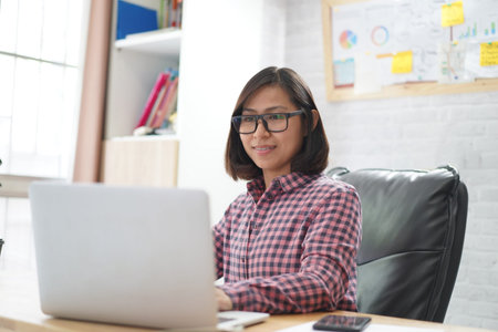 Young asian woman working on laptop in the home office