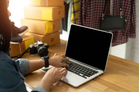 Women business owner working laptop computer selling onlineの写真素材