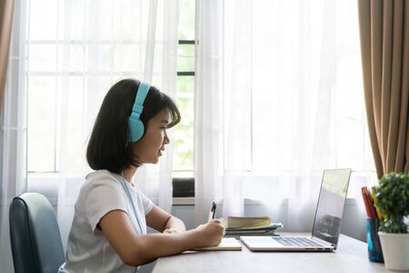 Asian girl studying homework online lesson at home, Social distance online education idea conceptの写真素材