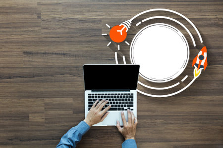 Top view Businessman working laptop on rocket launch with creative light bulb ideas, Startup...