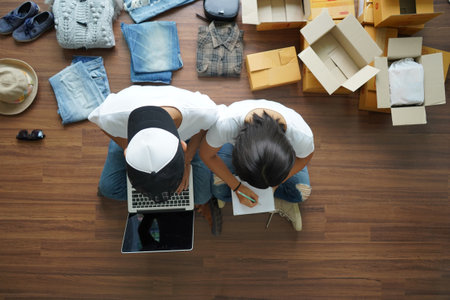 Top view women and men selling online start up small business owner, Working with using laptop computer and write a notebookの写真素材