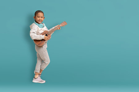 Funny asian child girl happiness on blue background