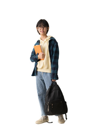 Happy Asian teen girl holding book and carry backpack, isolate on white background.の写真素材