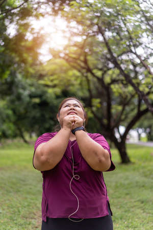 Fat woman asian exercise outdoors for weight loss idea concept.の写真素材