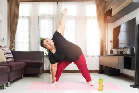 Asian woman fat workout at home, Sport exercising weight loss and recreation idea concept.の写真素材