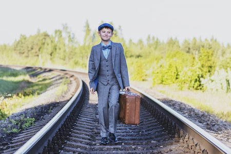 the boy waits for the train on the trackの写真素材