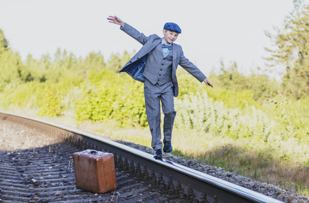 the boy waits for the train on the trackの写真素材