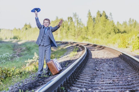 the boy waits for the train on the trackの写真素材