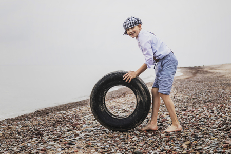 the boy at the top of an old tyreの写真素材