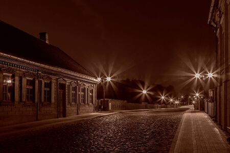 The old-fashioned Latvia.Kuldiga. ventas hub over the bridge at nightの写真素材