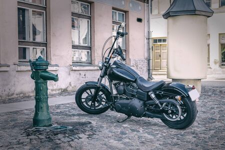 The street stands on an antique black motorcycleの写真素材