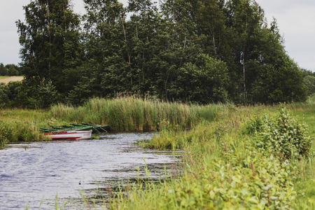 on the winding river stands several boatsの写真素材