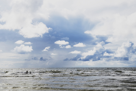 a few cumulus clouds above Latvia on the Baltic Seaの写真素材