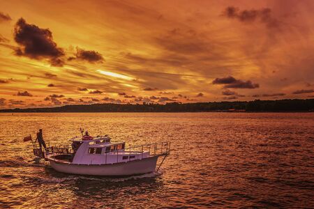 very beautiful colors in the evening sunlight shines on the ships in portの写真素材