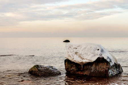 The evening sun glinting off the rocky seashoreの写真素材