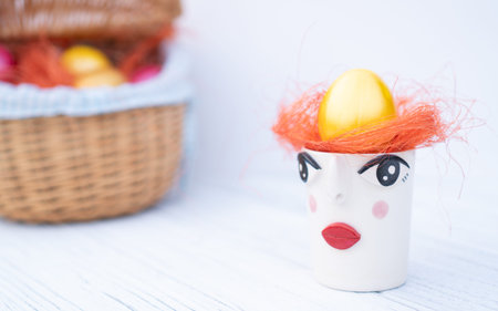 Modern and unusual Easter eggs tray with basket on the background.