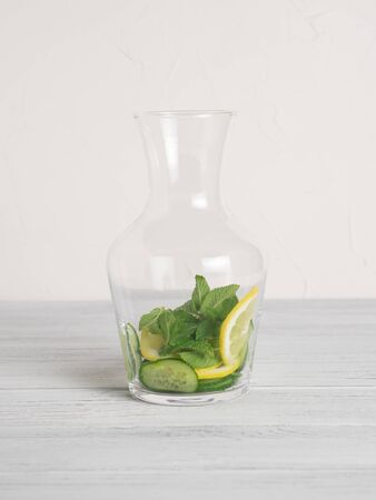 Jar with cucumber, lime slices and mint inside for cucumber water recipeの写真素材