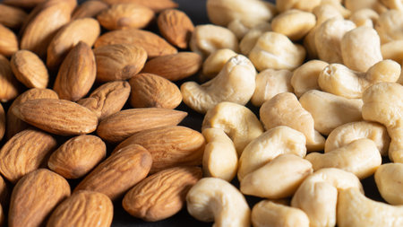 Organic peeled almond nuts and cashew seeds as background, top view. Healthy snack. Different healthy nutsの写真素材