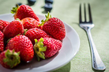 White plate with red strawberries.の写真素材