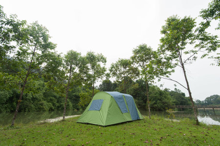 Tent camping near riverの写真素材
