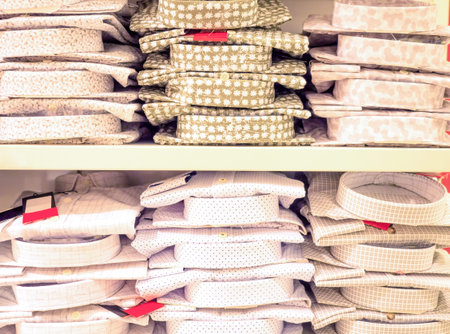 Stacks of male casual shirts on the rack in department store, close up. Shopping, sale, trade,...