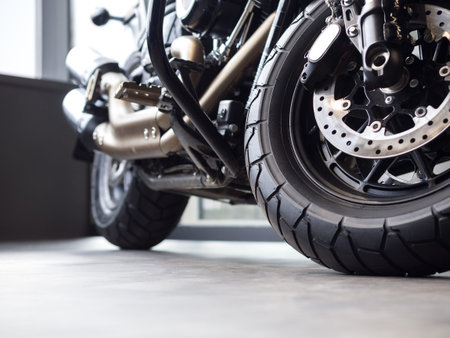 Black chrome new motorcycle on the floor in salon indoor. Details, rear wheel, wide angle, close up,...