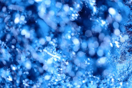 Defocus lights with bokeh glittering crystal blue background, soft focus. Winter and ice theme.の写真素材