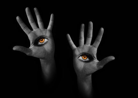 Bony pale demon hands with burning eyes on the palms on black background, surrealism. Monster, dead, Halloween, Samhain, witchcraft, evil, horror concept.の写真素材