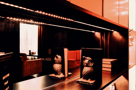 Decorative shelving and lounge bar interior through reflection in the mirror, blur stylization.