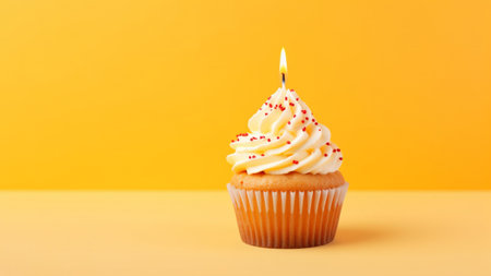 Tasty birthday cupcake with a candle on a yellow background. Mini cake. Ai generative.の素材