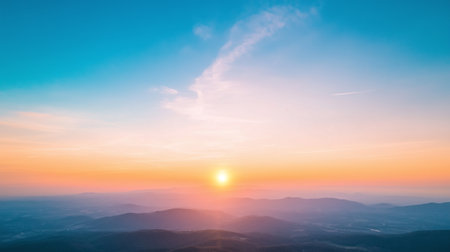 Breathtaking sunset over rolling hills, showcasing vibrant colors of orange, pink, and blue in sky. serene landscape that evokes sense of peace and tranquility.の素材