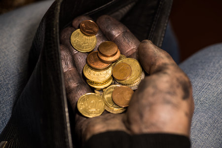 Dirty hands hold money from a wallet