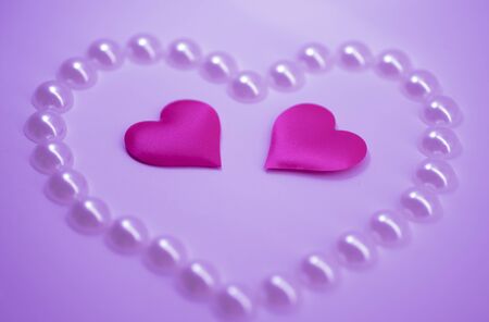 big pearl heart and two small pink hearts on a light-pink background, St.Petersburg. Valentine's Dayの写真素材