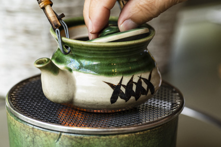 Sushi rolls, sashimi set, miso soup and teapot, on dark wooden table, Japanese food, top view.の写真素材