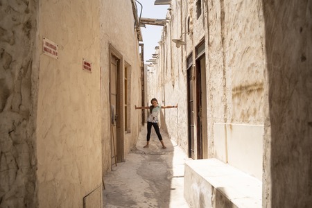 The modern city of Doha with palm tree, cars, wide avenues on a blue sky in Doha City.の写真素材