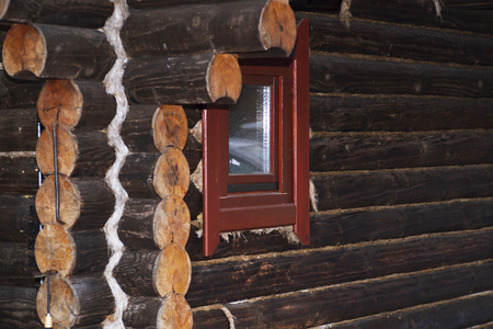 The old house, the corner of the house with logs, round bars on the wall of the house, the ends of felled beams.の写真素材