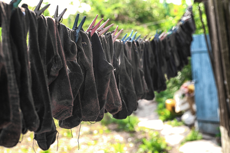 The washed socks are hung on the rope. Dry socks are dried on the street.の写真素材