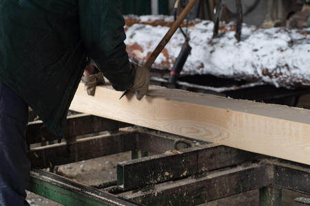 Cutting logs on the boards. In the winter process a tree.Wood processing.の写真素材