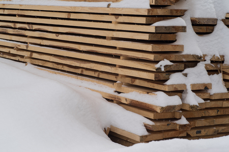 Stack of cut wood under the snow.Woodpile stacked of firewood under the snow.の写真素材