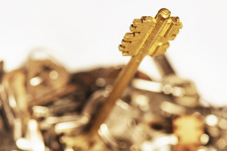 Many keys of different sizes. Keys on a white background, close-up. Selective focus, soft focus.の写真素材