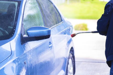 Cleaning Car Using High Pressure Water.Manual car wash with pressurized water in car wash outside.の写真素材