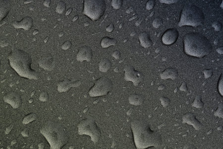Water droplets on black background.Fresh raw chicken fillet on a wooden cutting board.
