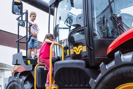 10.2019 Slovakia .Nitra.Tractor Great for agriculture at the show.Children visiting a huge tractor.のeditorial素材