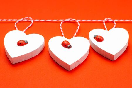 Valentine's Day Background.Valentines day concept. Greeting card. Copy space. Three wooden white hearts on a white background.の写真素材