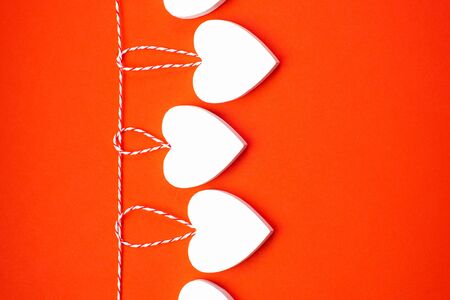 Valentine's Day Background.Valentines day concept. Greeting card. Copy space. Three wooden white hearts on a white background.の写真素材